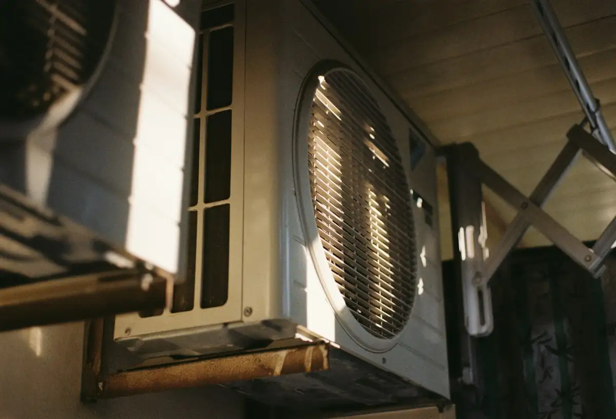 Technician checking an AC filter during a routine maintenance visit in a Dubai home